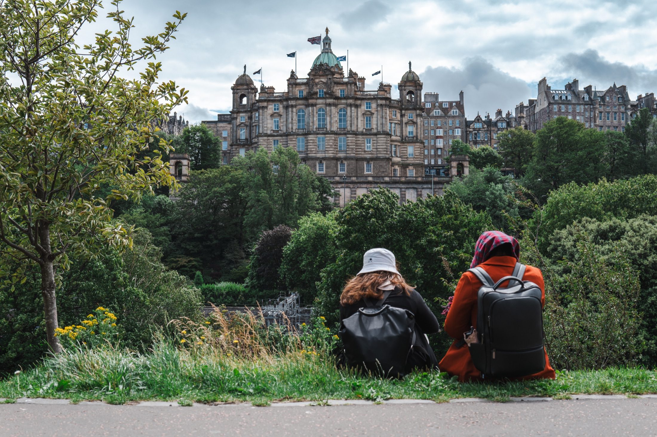 Two people overlook Edinburgh from a garden